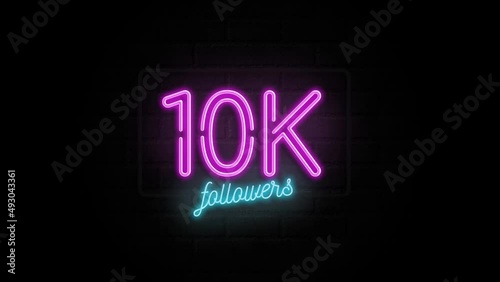 10K celebration neon sign on a brick wall photo