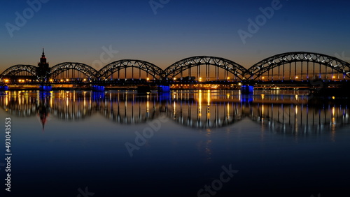 Dawn over the Daugava River in spring with the railway bridge as a backdrop