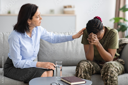 Complex PTSD. Psychologist Lady Comforting African American Military Woman At Therapy Session photo