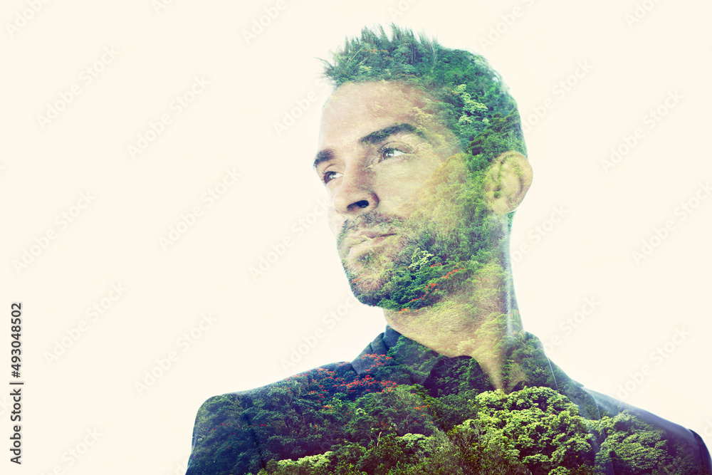 Survival of the fittest. Composite image of a handsome man superimposed with an image of a forest. - obrazy, fototapety, plakaty 