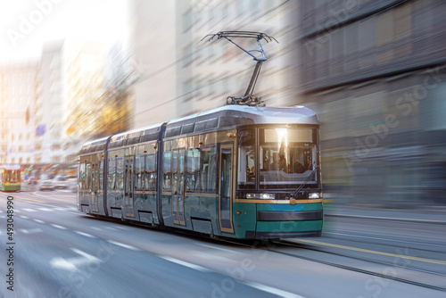 City tram rides through the streets of the city at a motion speed effect. photo