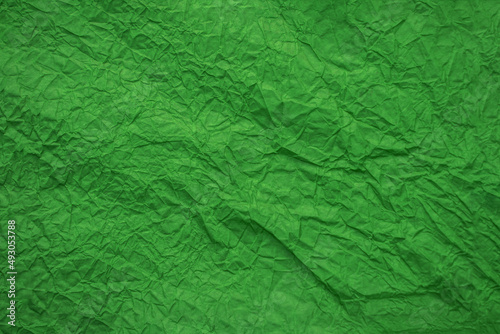 Background from crumpled green paper top view. Crumpled paper texture. Free space for text and advertising