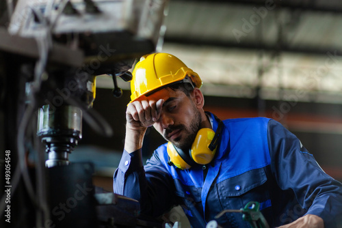 A male engineer or worker is stressed at work. heavy industrial plant concept