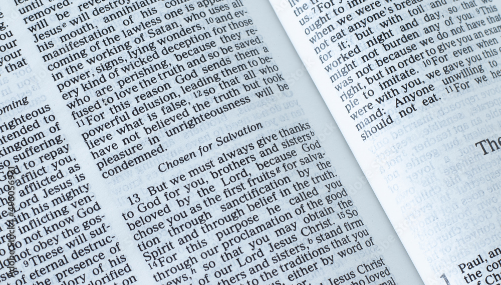 Open Holy Bible Book on biblical verses for salvation from God Jesus Christ. A closeup. The concept of chosen Christians (first fruits) saved by the LORD. Open Holy Bible Book on biblical verses for salvation from God Jesus Christ. A closeup. The concept of chosen Christians (first fruits) saved by the LORD.