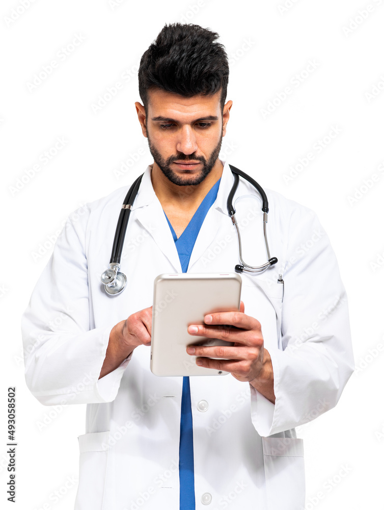 Young male doctor in medical coat using digital tablet isolated on white Young male doctor in medical coat using digital tablet isolated on white