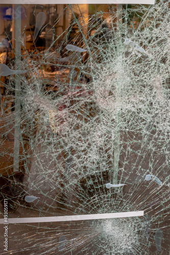 Damaged shop window. Broken glass. Violence concept. Lausanne, Switzerland.