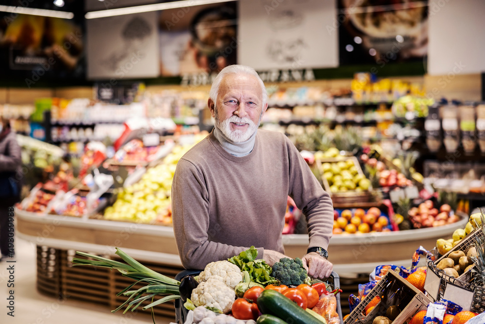 A healthy senior man shopping organic vegetables at the supermarket.
