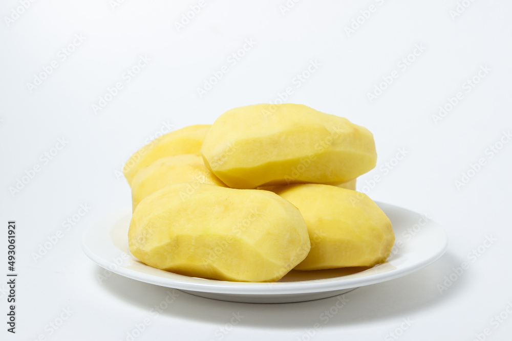 Peeled potatoes on a white background. Delicious and healthy vegetable. food preparation ingredient Peeled potatoes on a white background. Delicious and healthy vegetable. food preparation ingredient
