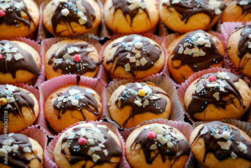 Muffins close-up with chocolate, colorful sugar sprinkles and decoration for children's birthday party.