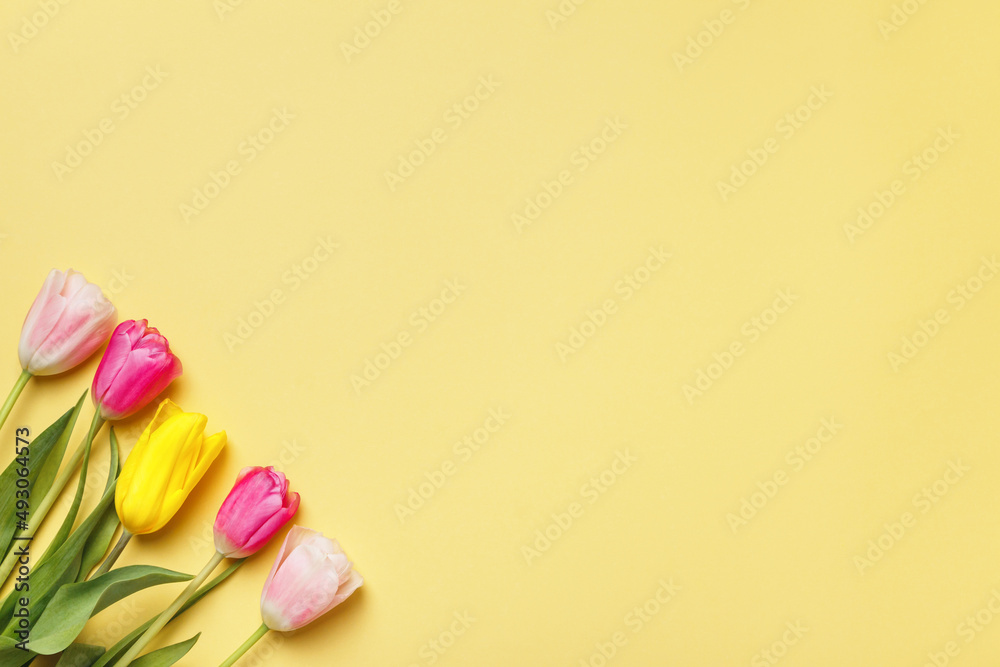 Easter greeting card flowers tulips on a yellow background. copy space
