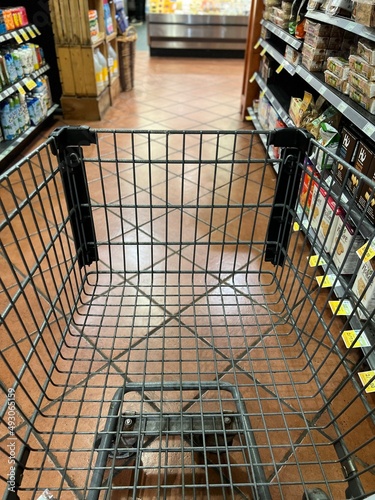 Grocery cart on a shopping trip going through the aisles.
