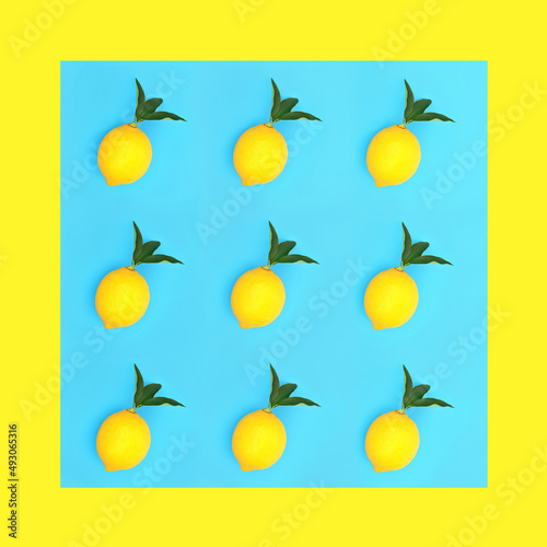 Fototapeta Naklejka Na Ścianę i Meble -  Lemon fruit with green leaves on blue background with yellow border. Minimal design for good health and weight loss concept. High in antioxidants, bioflavonoids and vitamin c.