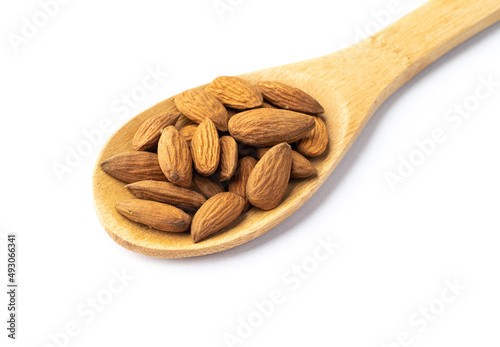 Almonds on a spoon isolated over white background