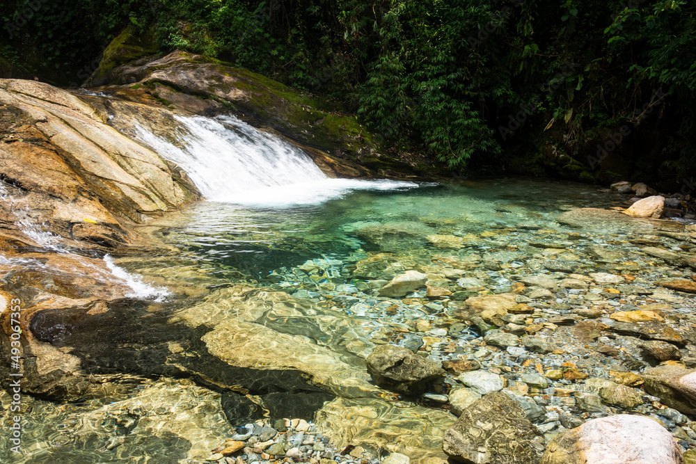 Beautiful view to green atlantic rainforest waterfall with blue water Beautiful view to green atlantic rainforest waterfall with blue water