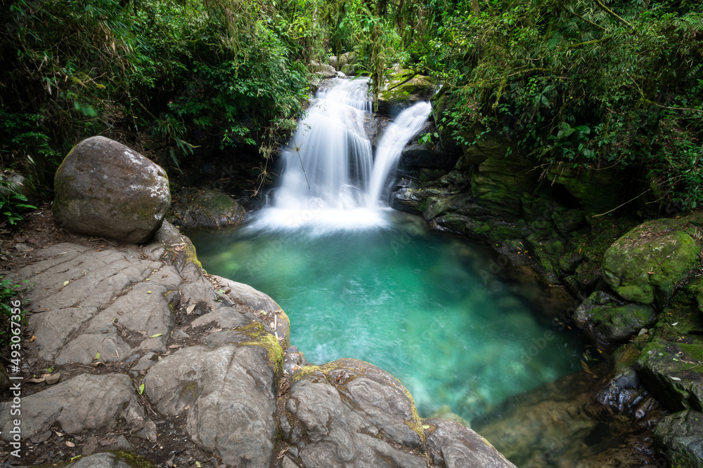 Beautiful view to green atlantic rainforest waterfall with blue water Beautiful view to green atlantic rainforest waterfall with blue water