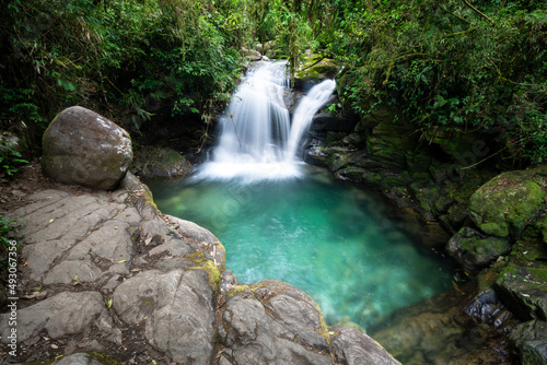 Beautiful view to green atlantic rainforest waterfall with blue water © Cavan