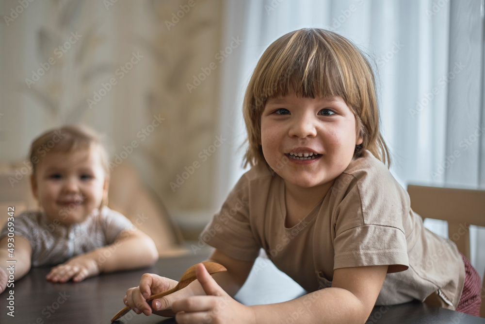 Two children look at the camera and smile. Two children look at the camera and smile.