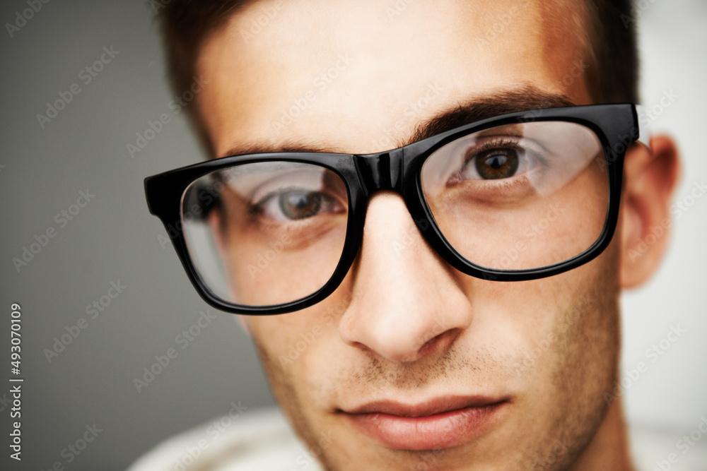 Looking into the eyes of a Hipster. Portrait close up of a man with hipster glasses on.