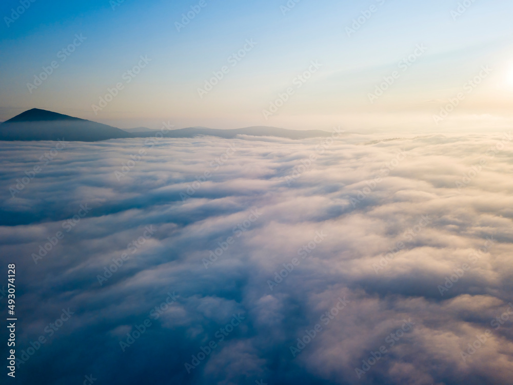 High flight above the clouds. Aerial drone view.