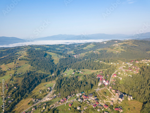 Green mountains of Ukrainian Carpathians in summer. Sunny day. Aerial drone view.