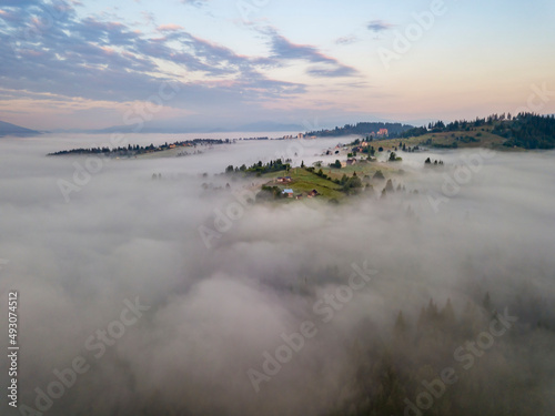 Fototapeta Naklejka Na Ścianę i Meble -  Sunrise over the fog in the Ukrainian Carpathians. Aerial drone view.