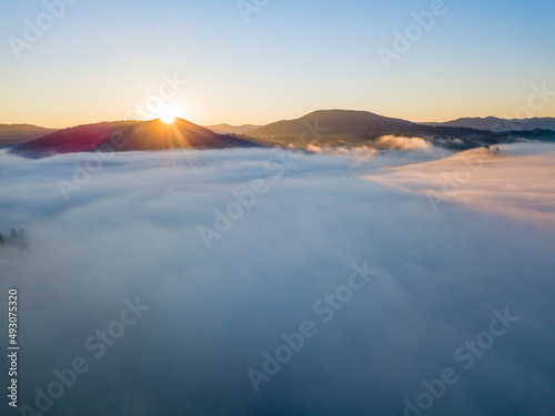 Sunrise over the fog in the Ukrainian Carpathians. Aerial drone view.