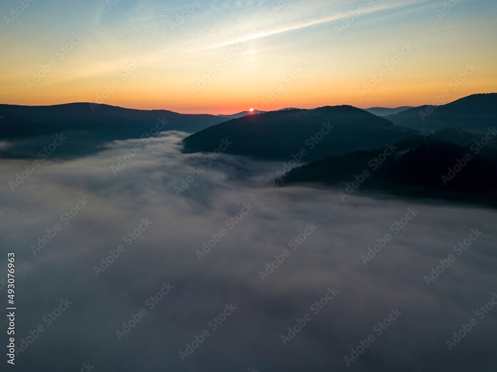 Sunrise over the fog in the Ukrainian Carpathians. Aerial drone view.