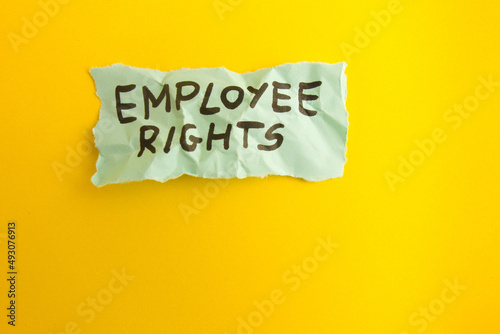 Words employee rights handwritten on yellow background photo