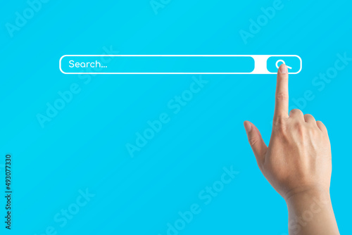Hand with a finger touch on search symbol on the internet for searching the information data on blue background.