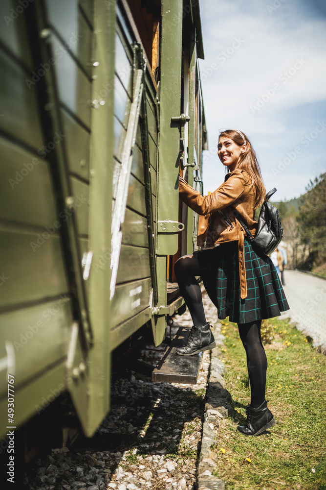 Woman Entering The Wagon Of Retro Train And Traveling To Adventure