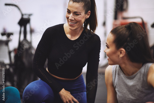 Laughing woman talking with friends after a gym class