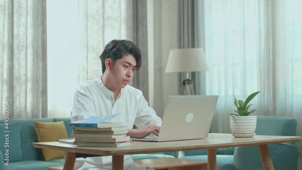 Asian Man Student Using Computer To Study Online At Home
Asian Man Student Using Computer To Study Online At Home