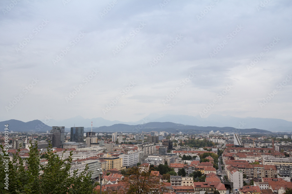 Panoramic view of Downtown Ljubljana, Slovenia taken from above during a cloudy grey sky afternoon seen from above with residential towers. Ljubljana is the biggest city and the capital of Slovenia... Panoramic view of Downtown Ljubljana, Slovenia taken from above during a cloudy grey sky afternoon seen from above with residential towers. Ljubljana is the biggest city and the capital of Slovenia...