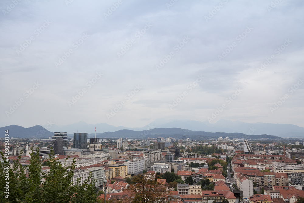 Panoramic view of Downtown Ljubljana, Slovenia taken from above during a cloudy grey sky afternoon seen from above with residential towers. Ljubljana is the biggest city and the capital of Slovenia...