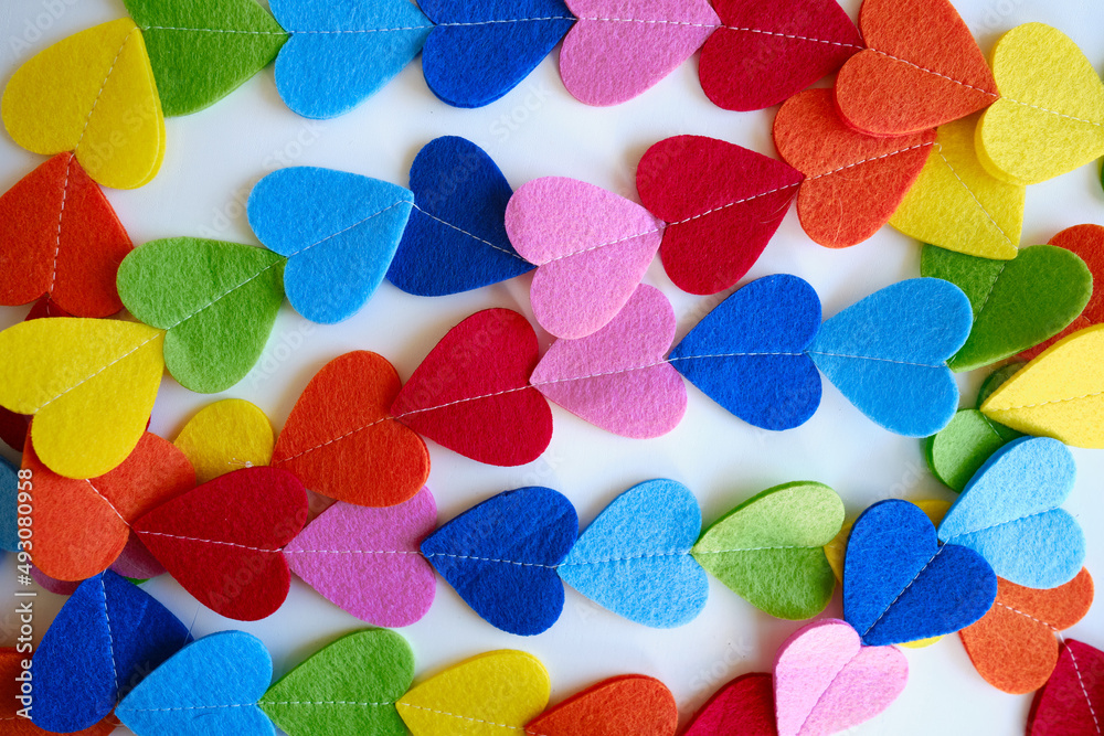 Colored hearts on a white background. Valentine's Day concept. Place for text and background texture. Colorful love Colored hearts on a white background. Valentine's Day concept. Place for text and background texture. Colorful love