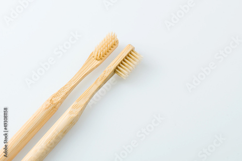 wooden toothbrushes on white background © drummatra