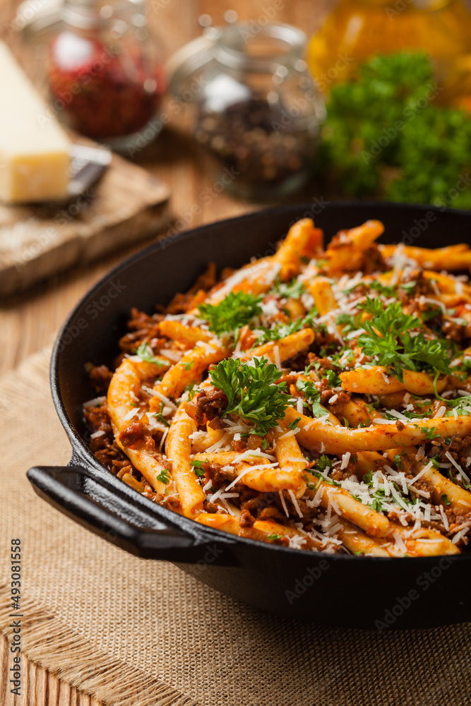 Maccheroni al ferretto with beef in ragu bolognese. Front view. Maccheroni al ferretto with beef in ragu bolognese. Front view.