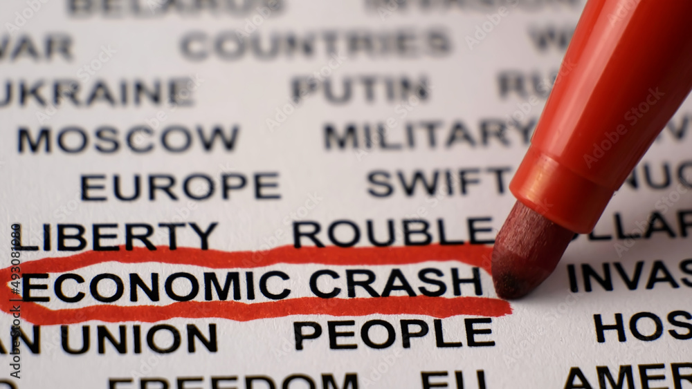 Closeup shot of ECONOMIC CRASH written on white paper with a red circle. Military activities. Sanctions. Crisis. Russian invasion of Ukraine concept. Closeup shot of ECONOMIC CRASH written on white paper with a red circle. Military activities. Sanctions. Crisis. Russian invasion of Ukraine concept.