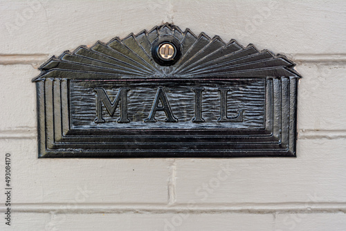 Mail letterbox slot in black metal traditional with words Mail printed on it.