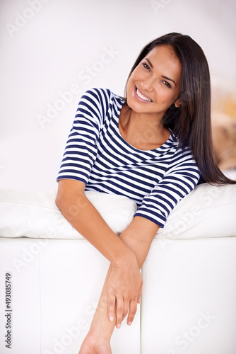 Ready to take this day by the horns. Closeup of a young woman leaning on her couch.