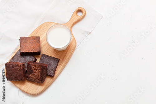 Slices of brownie dessert on a light background
