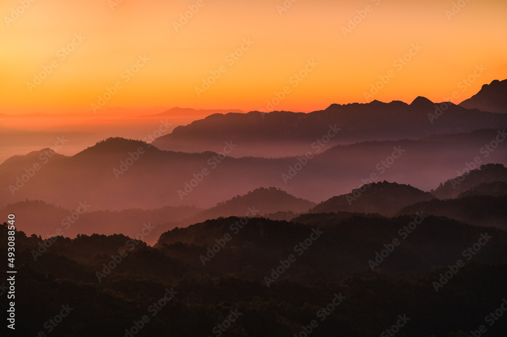 Beautiful golden sky with mountain layers in the morning