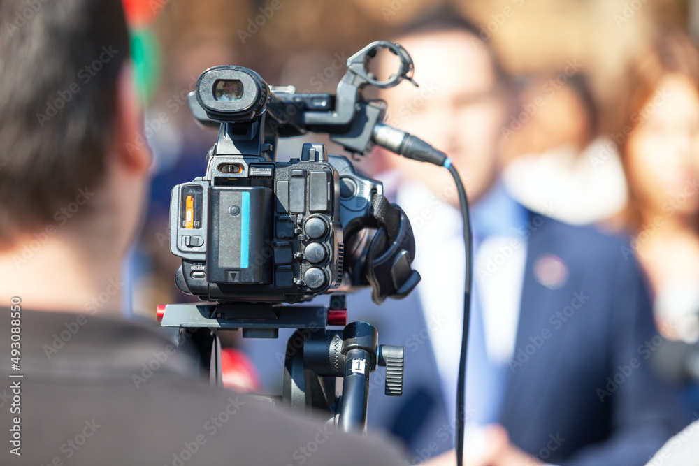 Filming media event or news conference with a video camera