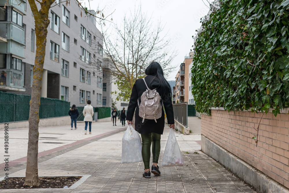 Naklejka premium Woman returns home with shopping bags