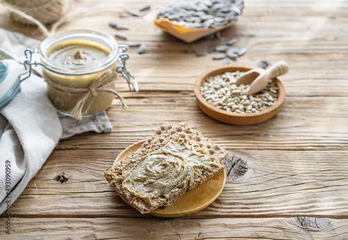 Homemade sunflower seed spread - sunbutter with seeds on a wooden background