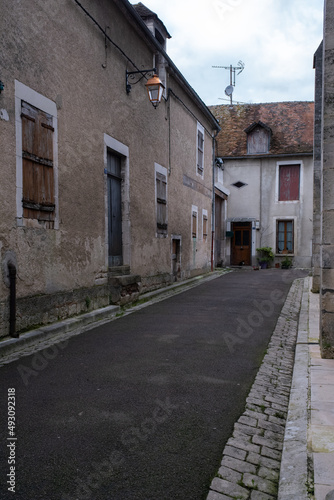 Fototapeta Naklejka Na Ścianę i Meble -  Chablis, France - February 23, 2022: Chablis is a town in the Bourgogne-Franche-Comte famous for its french white wine. Cloudy winter day. Selective focus.