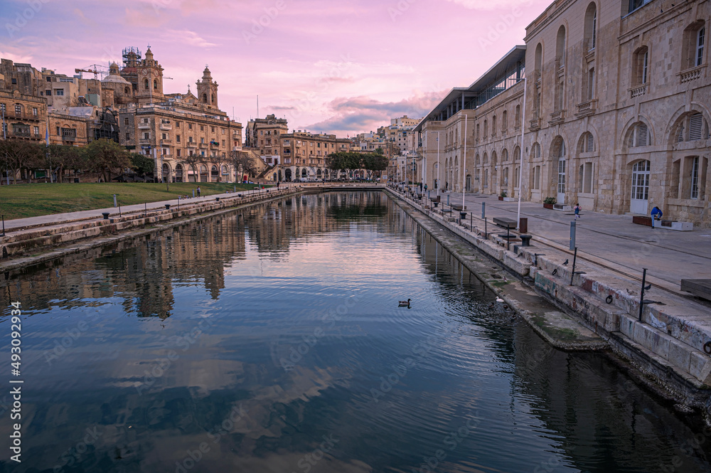 Sunset over small canal in Cospicua, Malta