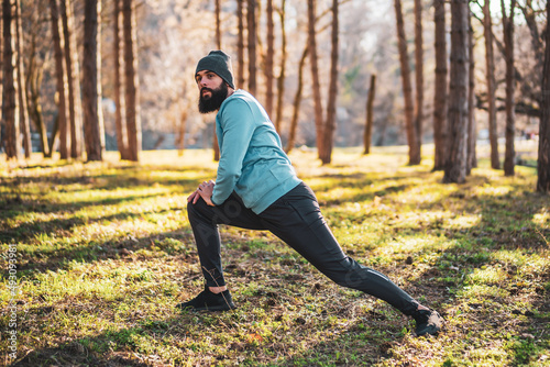 Man with beard enjoys exercising in nature.
