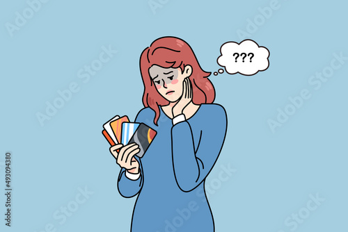 Unhappy woman holding credit cards feel confused with bank loan. Upset female client with deposit card distressed with bankruptcy or financial problems. Flat vector illustration. 