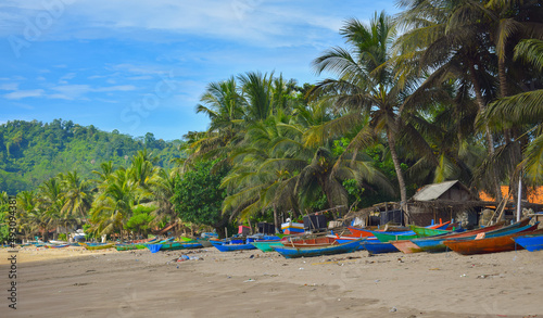 Traditional wooden fishing boats and beautiful hilly beach in East Java province, Indonesia. boat background on the beach, beautiful Indonesian beaches. beach background.